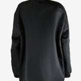 Black jacket worn by a person, showing the jacket's fit