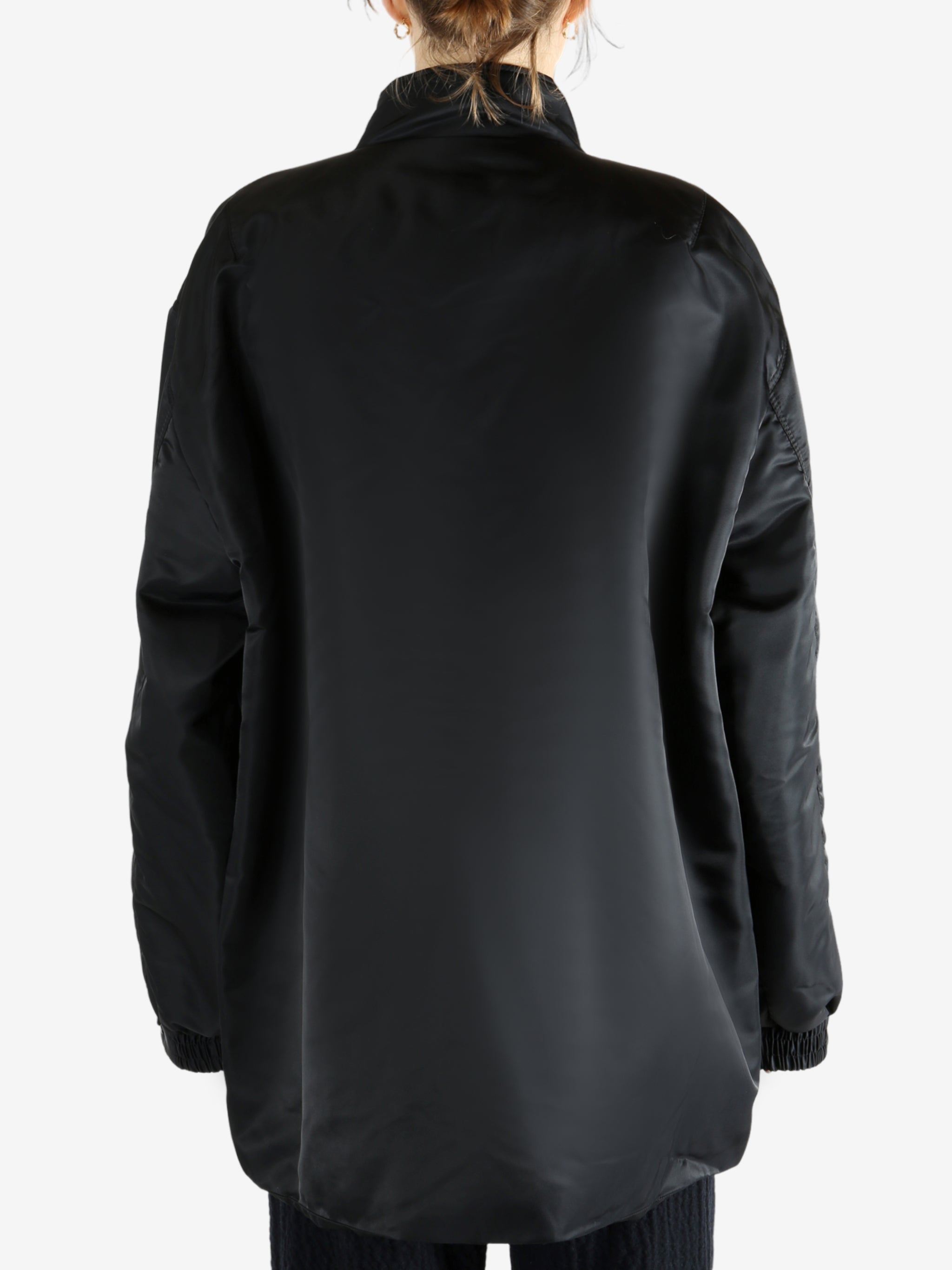 Black jacket worn by a person, showing the jacket's fit