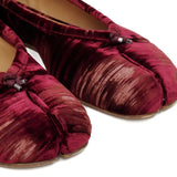 Close up of the red shoes, showing texture of the viscose and cupro fabric