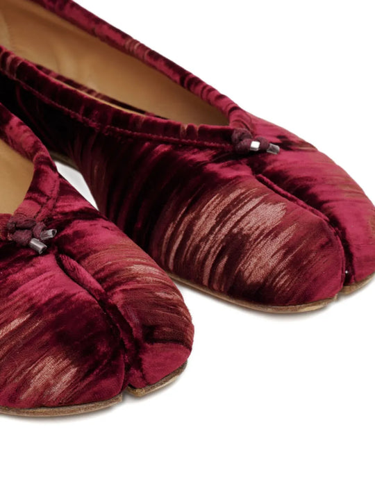 Close up of the red shoes, showing texture of the viscose and cupro fabric