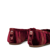 Close up of the red shoes, showing texture of the viscose and cupro fabric