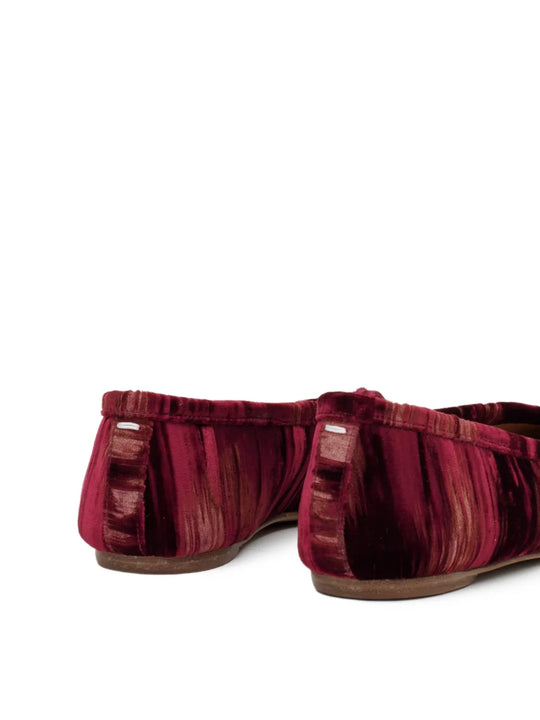 Close up of the red shoes, showing texture of the viscose and cupro fabric