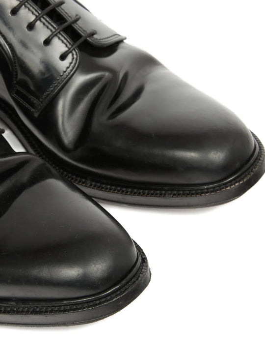 Close up of black shoes, showing texture of the leather fabric