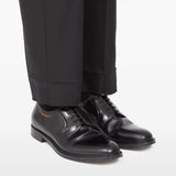 Black shoes worn by a person, showing the shoes fit