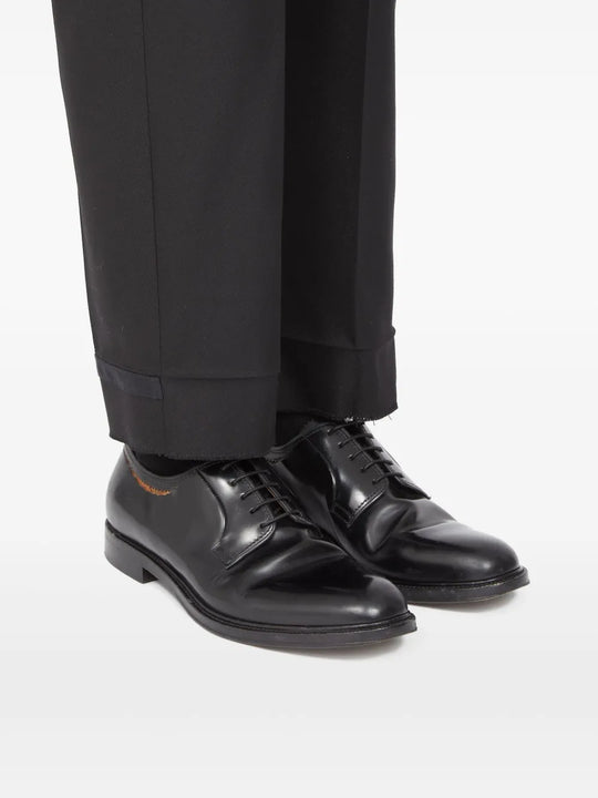 Black shoes worn by a person, showing the shoes fit