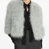 Grey coat worn by a person, showing the coat fit