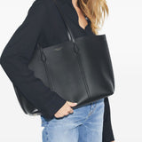 Black bags worn by a person, showing the bags fit