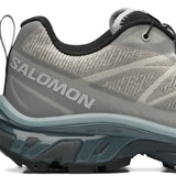 Close up of grey sneakers, showing texture of the synthetic rubber fabric