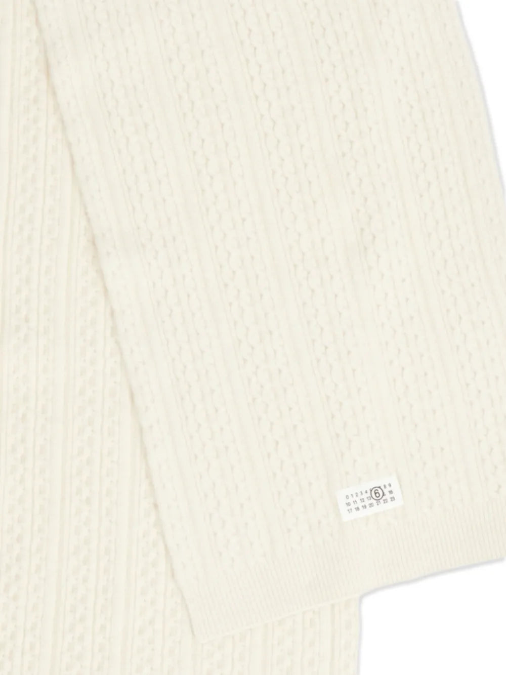 Close up of the white scarf, showing texture of the wool and acrylic fabric