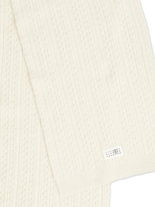 Close up of the white scarf, showing texture of the wool and acrylic fabric