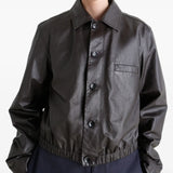 Brown tops worn by a person, showing the tops fit