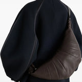 Brown bag worn by a person, showing the bag's fit