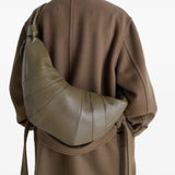 Green bag worn by a person, showing the bag's fit