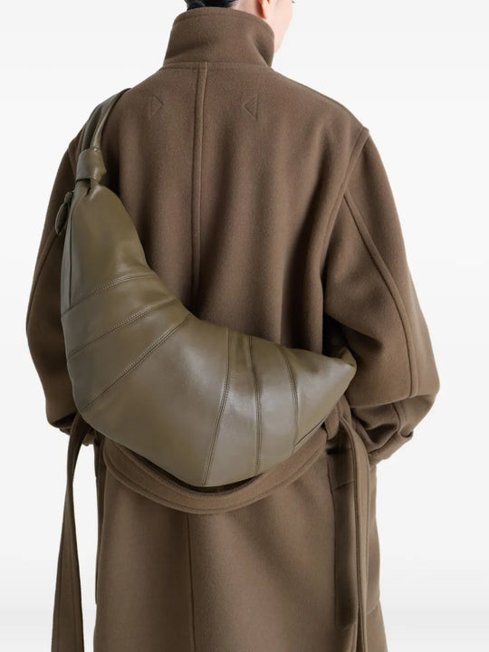 Green bag worn by a person, showing the bag's fit