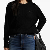 Black sweater worn by a person, showing the sweater's fit