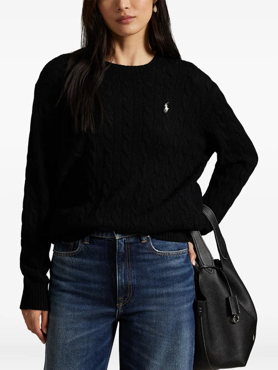 Black sweater worn by a person, showing the sweater's fit