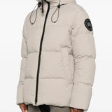 Tan coats worn by a person, showing the coats fit