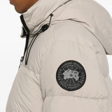 Close up of tan coats , showing texture of the recycled polyamide and feather and down fabric