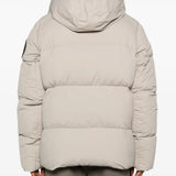 Tan coats worn by a person, showing the coats fit