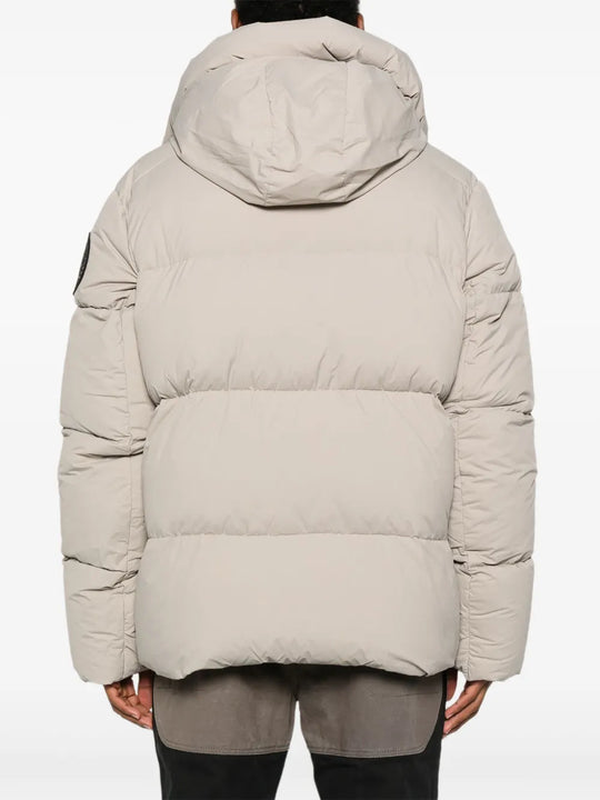 Tan coats worn by a person, showing the coats fit