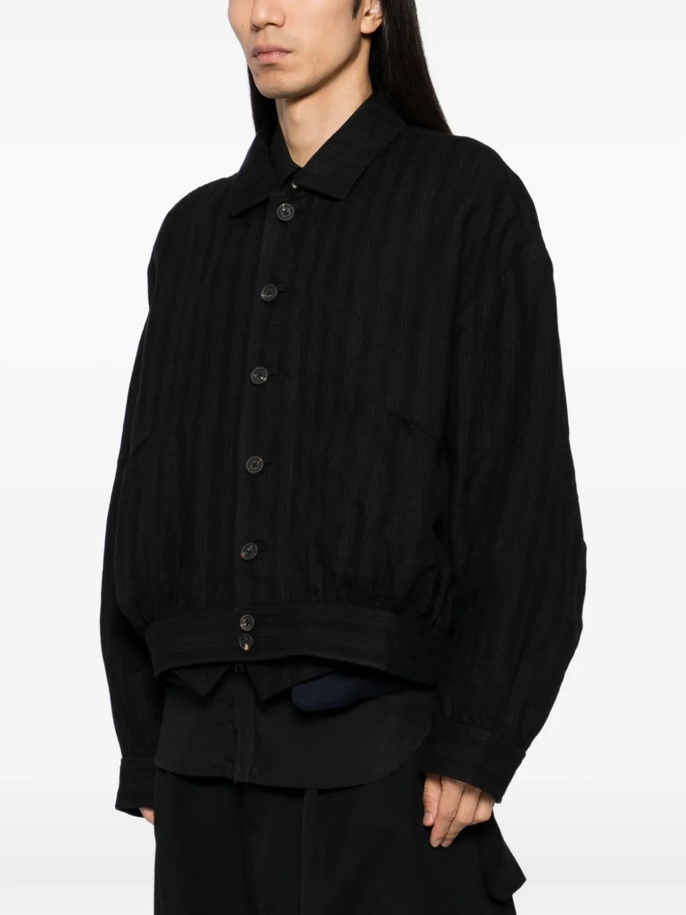 Black jacket worn by a person, showing the jacket's fit