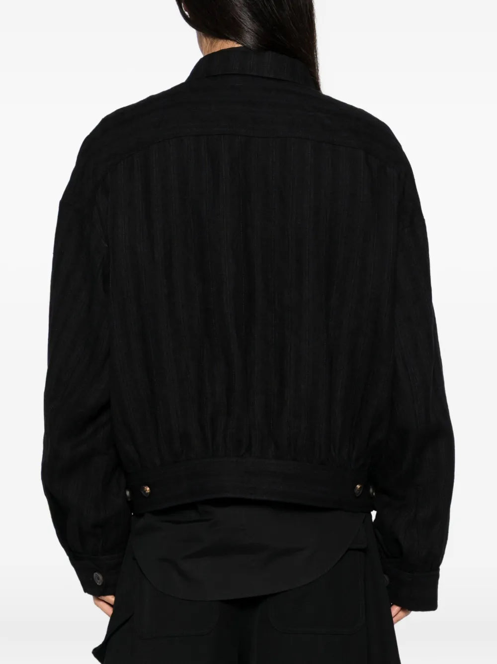 Black jacket worn by a person, showing the jacket's fit