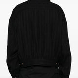 Black jacket worn by a person, showing the jacket's fit