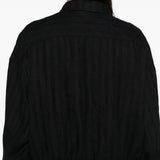 Close up of the black jacket, showing texture of the linen fabric