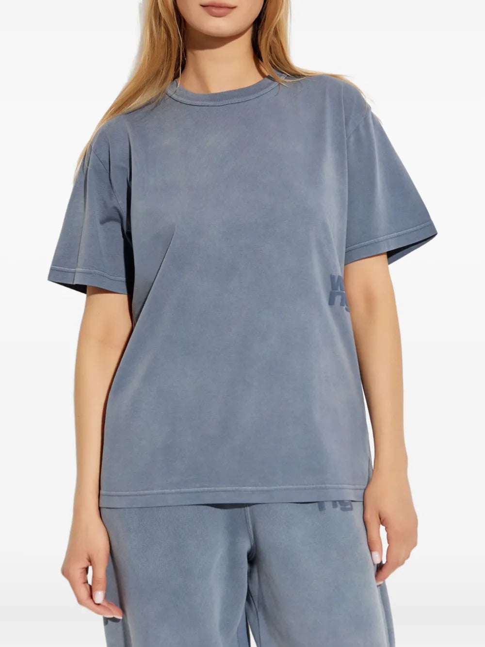 Blue t-shirt worn by a person, showing the shirt's fit