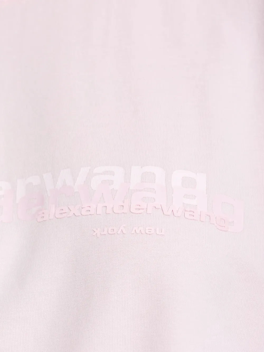 Close up of the pink t-shirt, showing texture of the cotton fabric