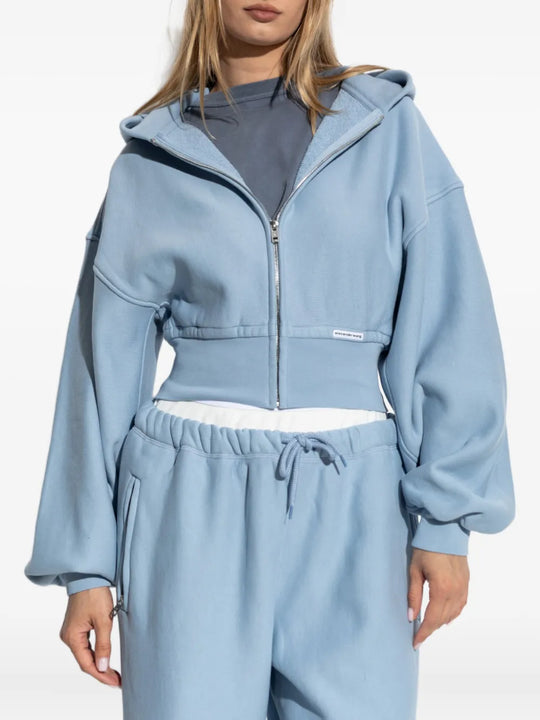Blue hoodie worn by a person, showing the hoodie fit