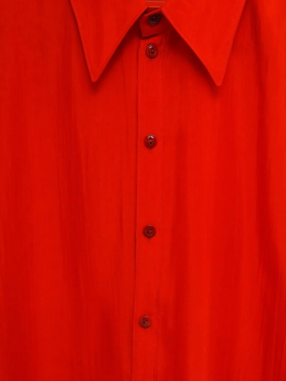 Close up of the red shirt, showing texture of the cotton fabric