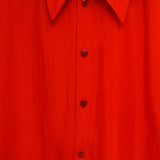 Close up of the red shirt, showing texture of the cotton fabric