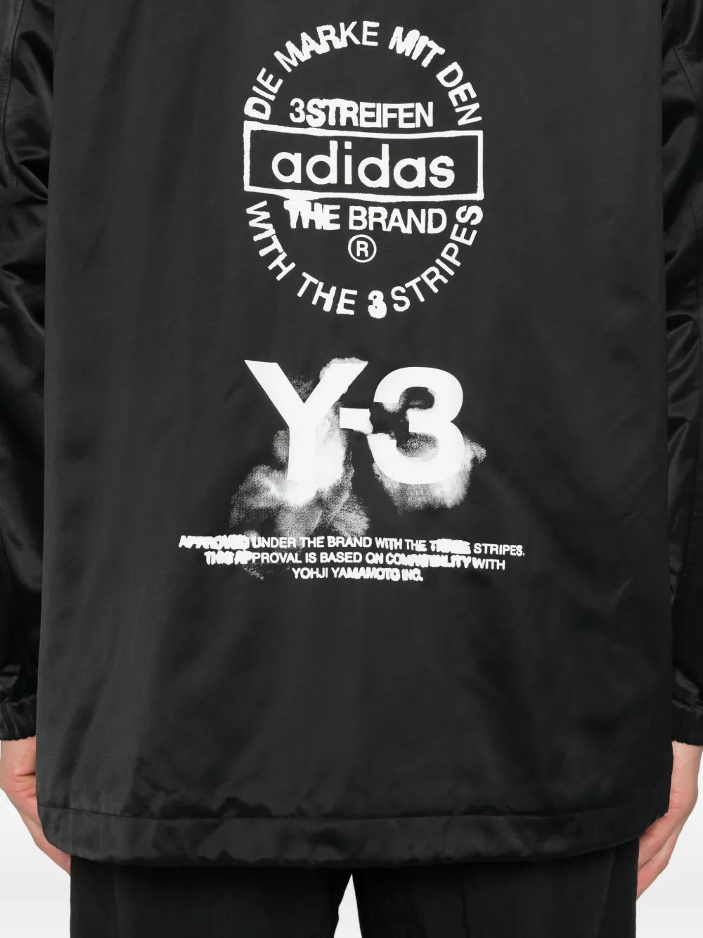 Close up of black jacket,showing texture of the recycled polyacrylic fabric.