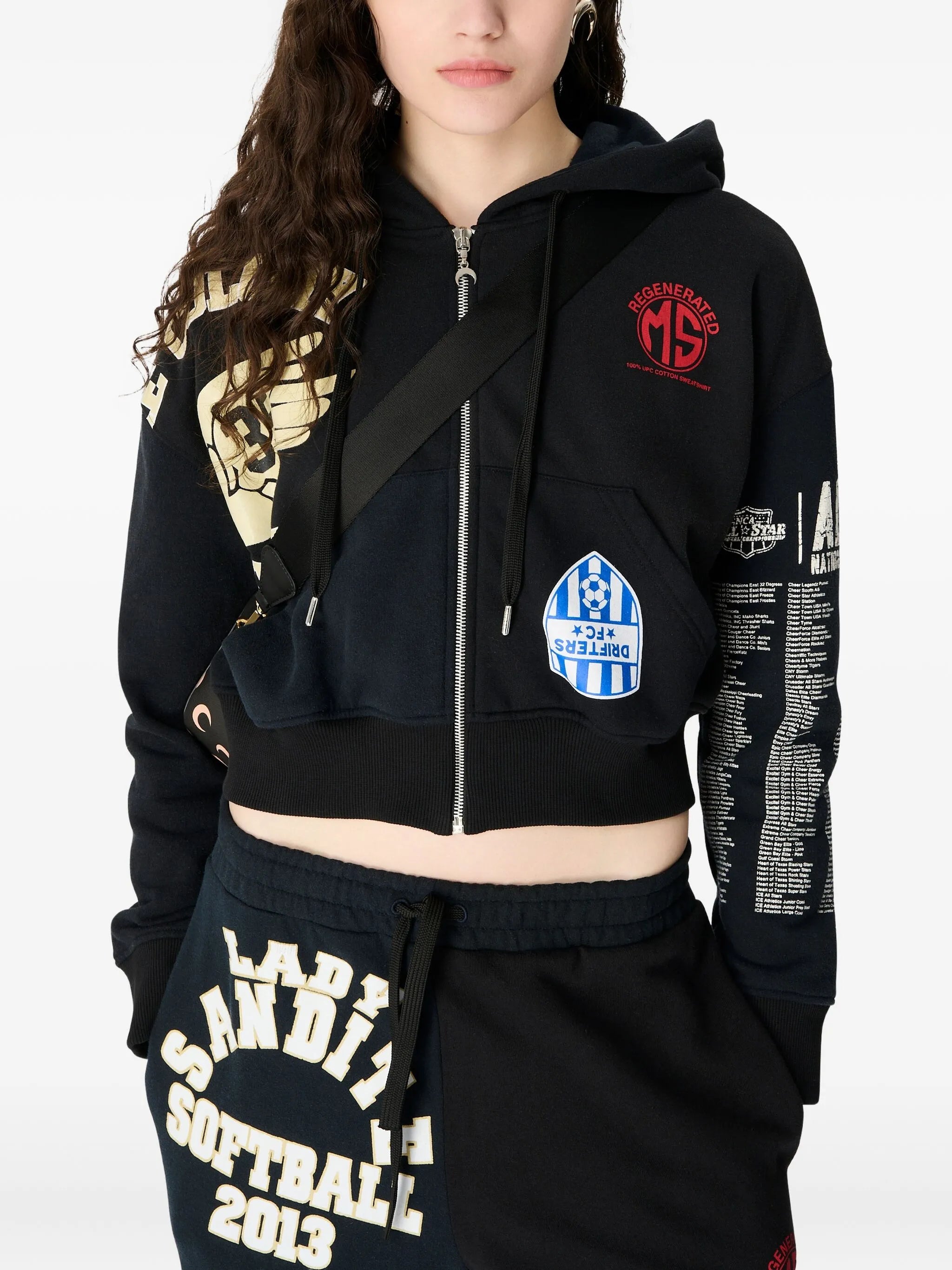 black hoodie worn by a person, showing the hoodie fit