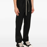 Black pants worn by a person, showing the pants's fit