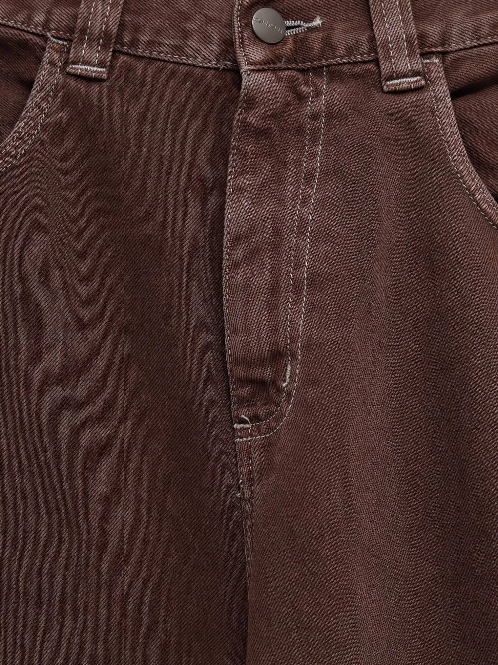 Close up of brown pant,showing texture of the cotton fabric.