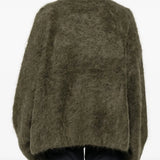 Brown knitwear worn by a person, showing the knitwear fit