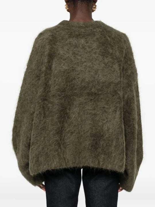 Brown knitwear worn by a person, showing the knitwear fit