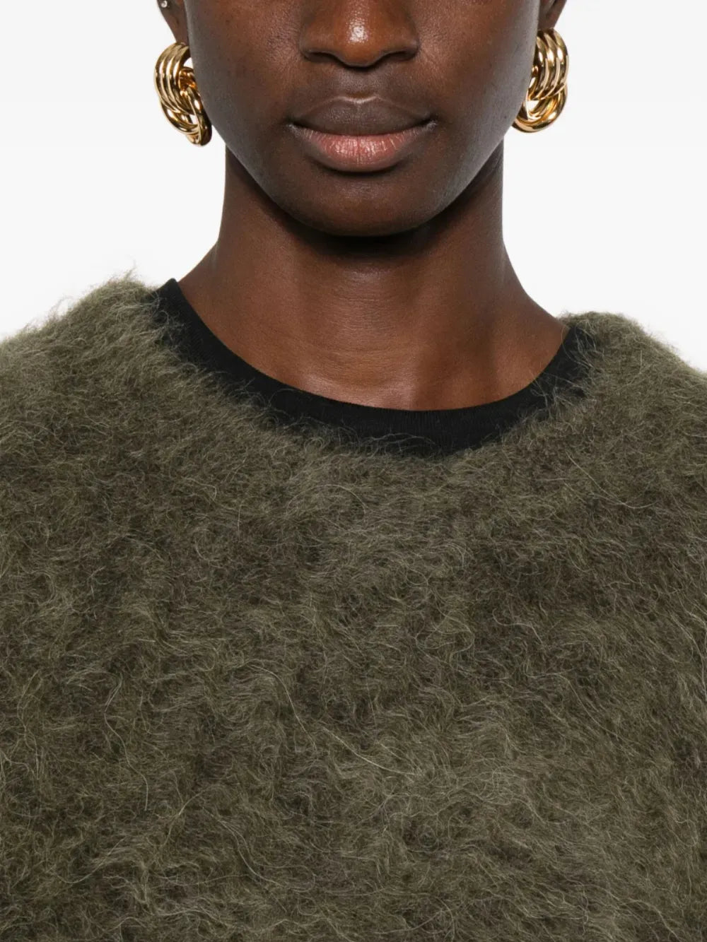 Brown knitwear worn by a person, showing the knitwear fit