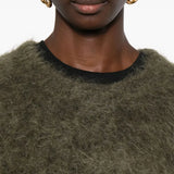 Brown knitwear worn by a person, showing the knitwear fit