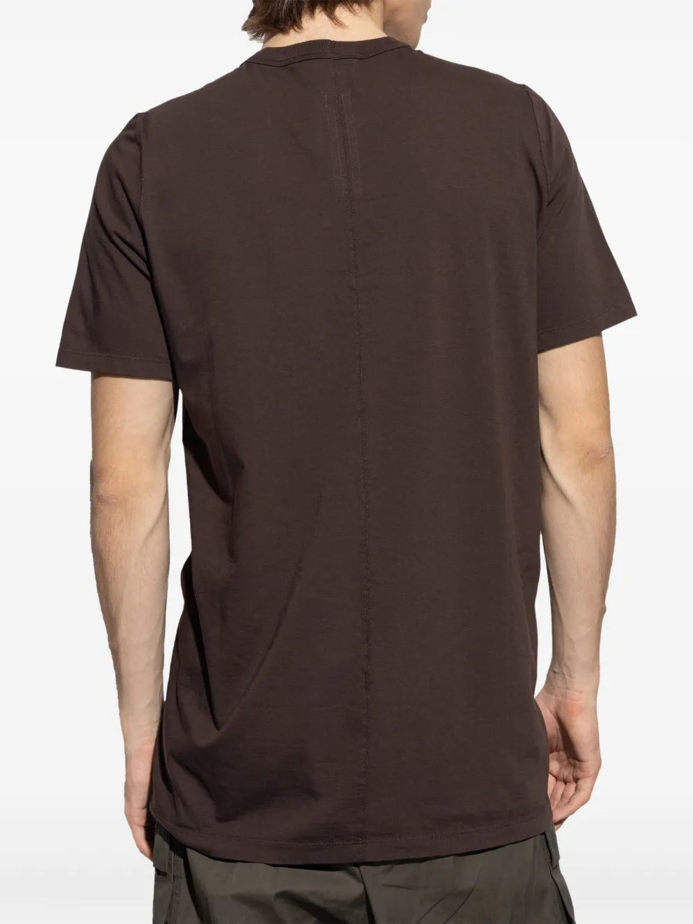 Brown t-shirt worn by a person, showing the shirt's fit