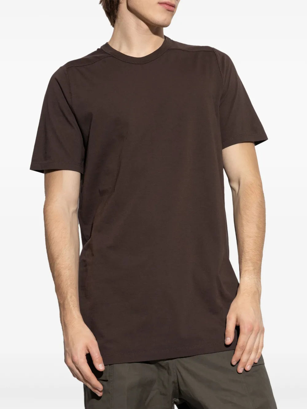 Brown t-shirt worn by a person, showing the shirt's fit