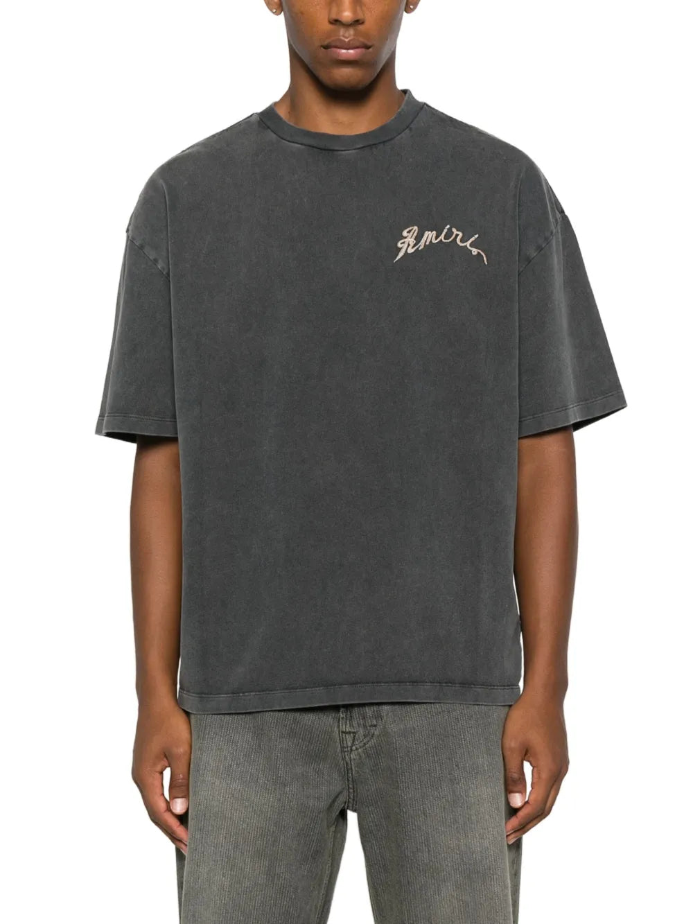 Black t-shirts worn by a person, showing the t-shirts fit