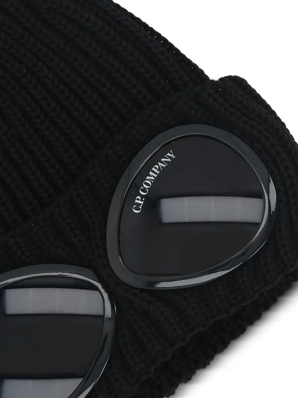 Close up of the black beanie, showing texture of the wool fabric