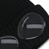 Close up of the black beanie, showing texture of the wool fabric