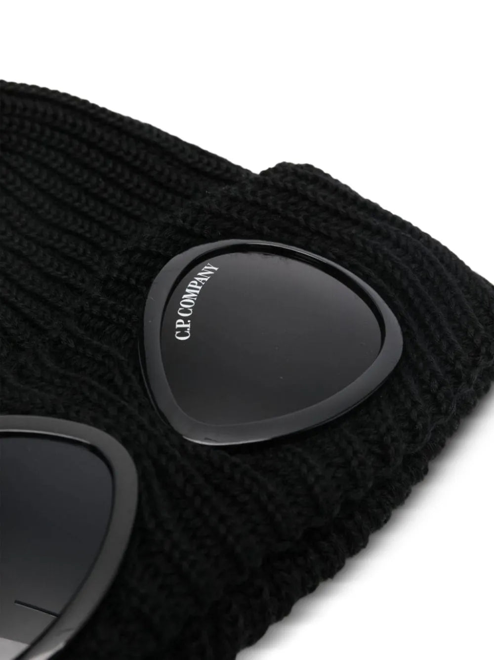 Close up of the black beanie, showing texture of the wool fabric