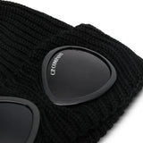 Close up of the black beanie, showing texture of the wool fabric