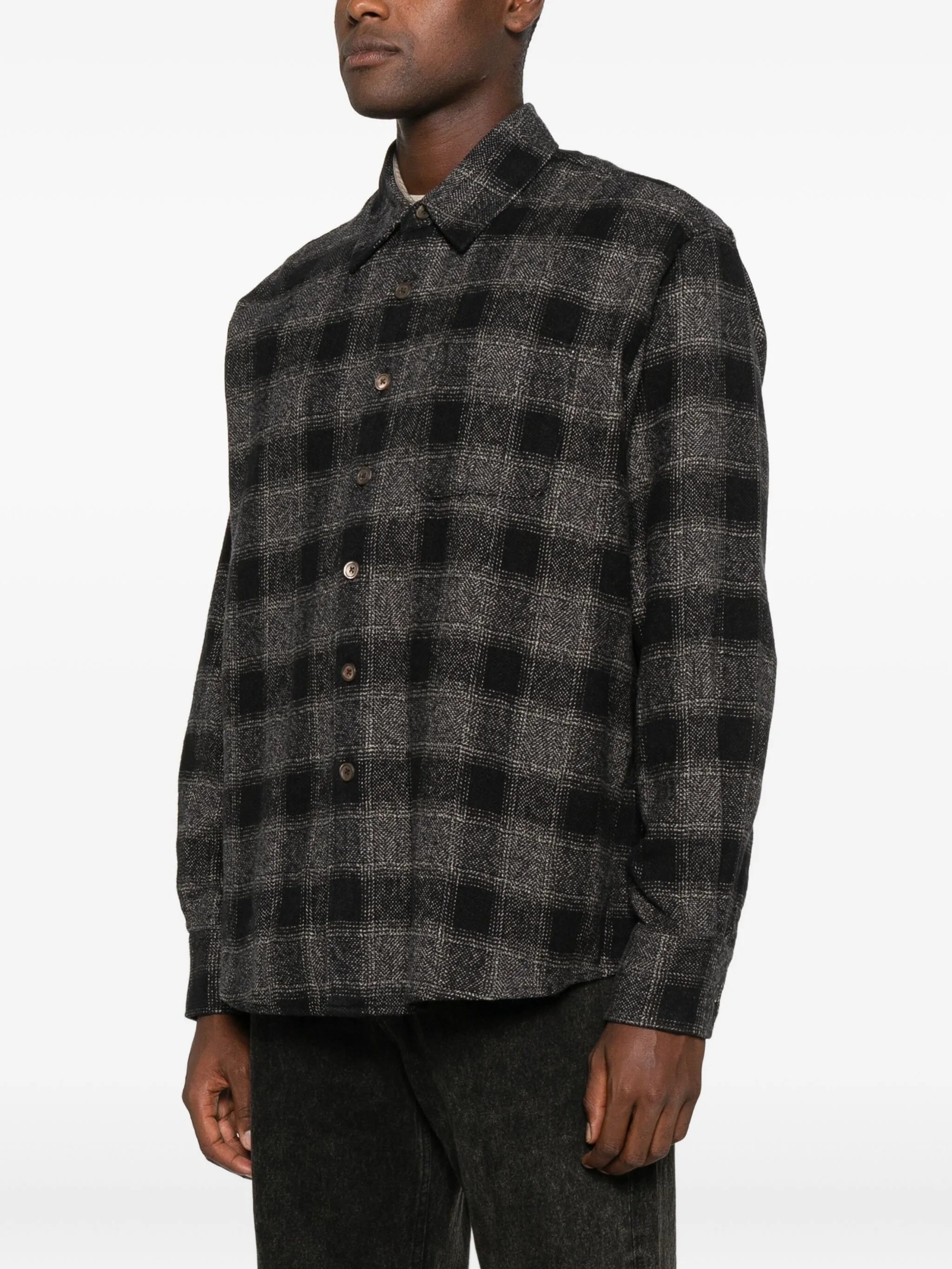 Grey shirt worn by a person, showing the shirt's fit