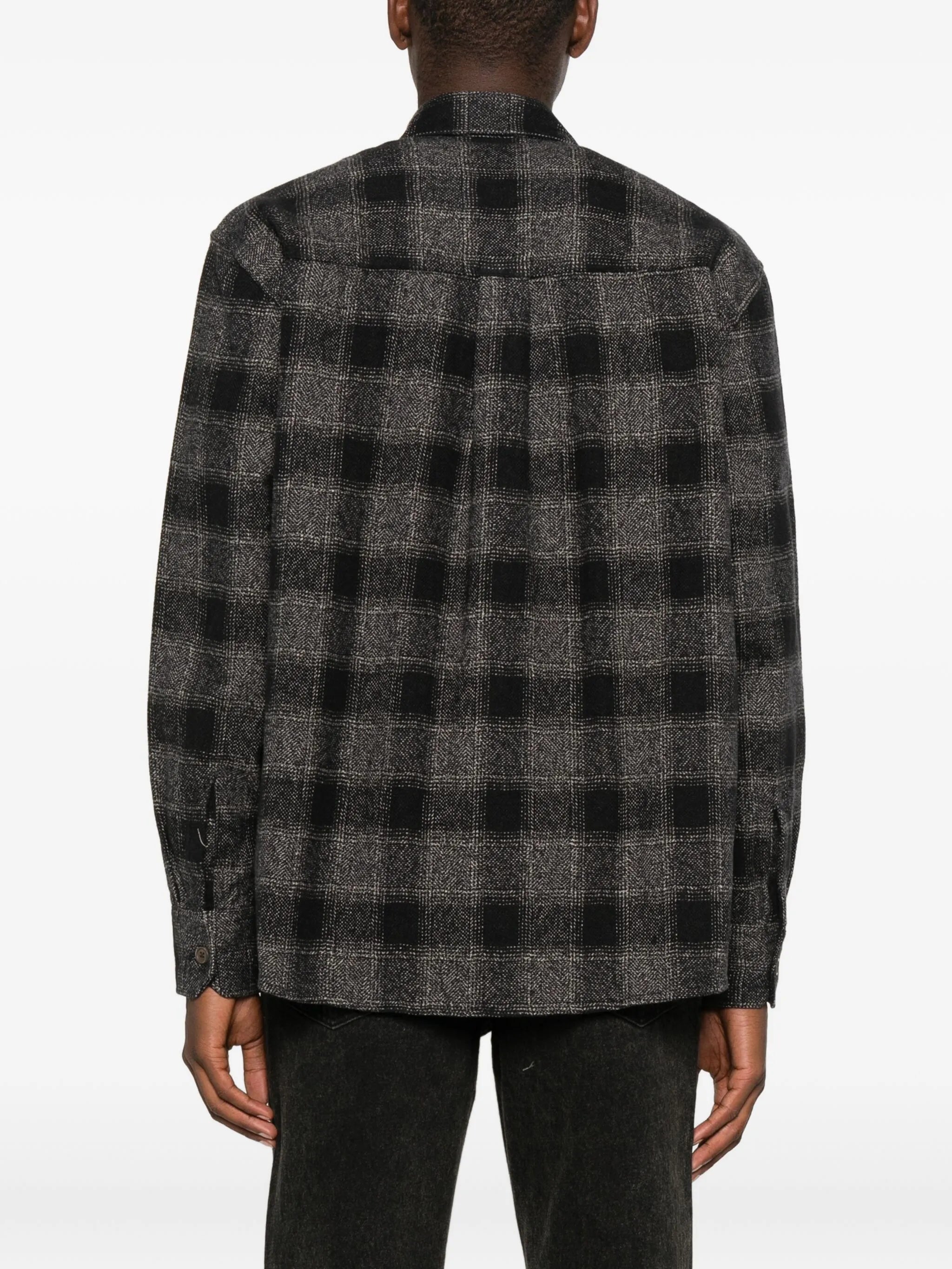 Grey shirt worn by a person, showing the shirt's fit